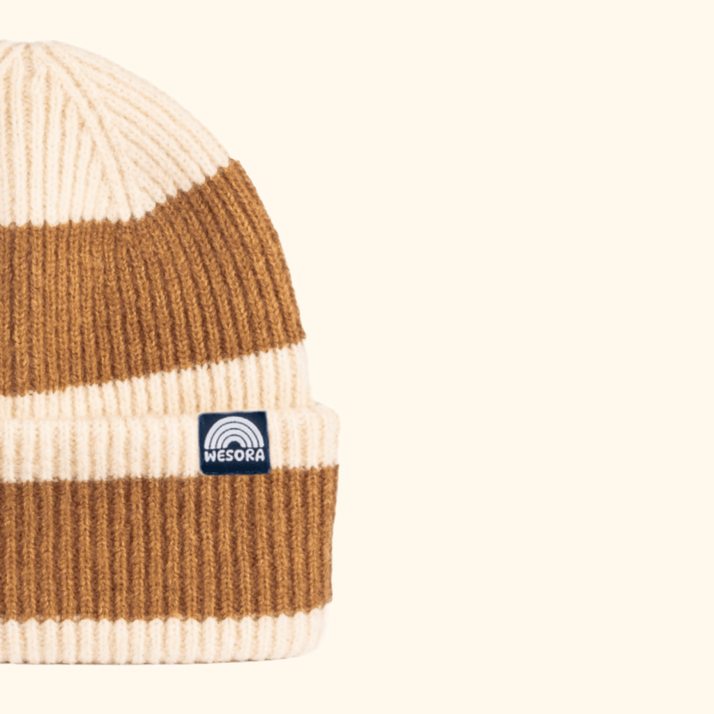 Beanie - Toffee Twist mit breiten Streifen und WESORA-Label auf der Krempe, doppellagig gestrickt für Komfort, fotografiert vor hellem Hintergrund.