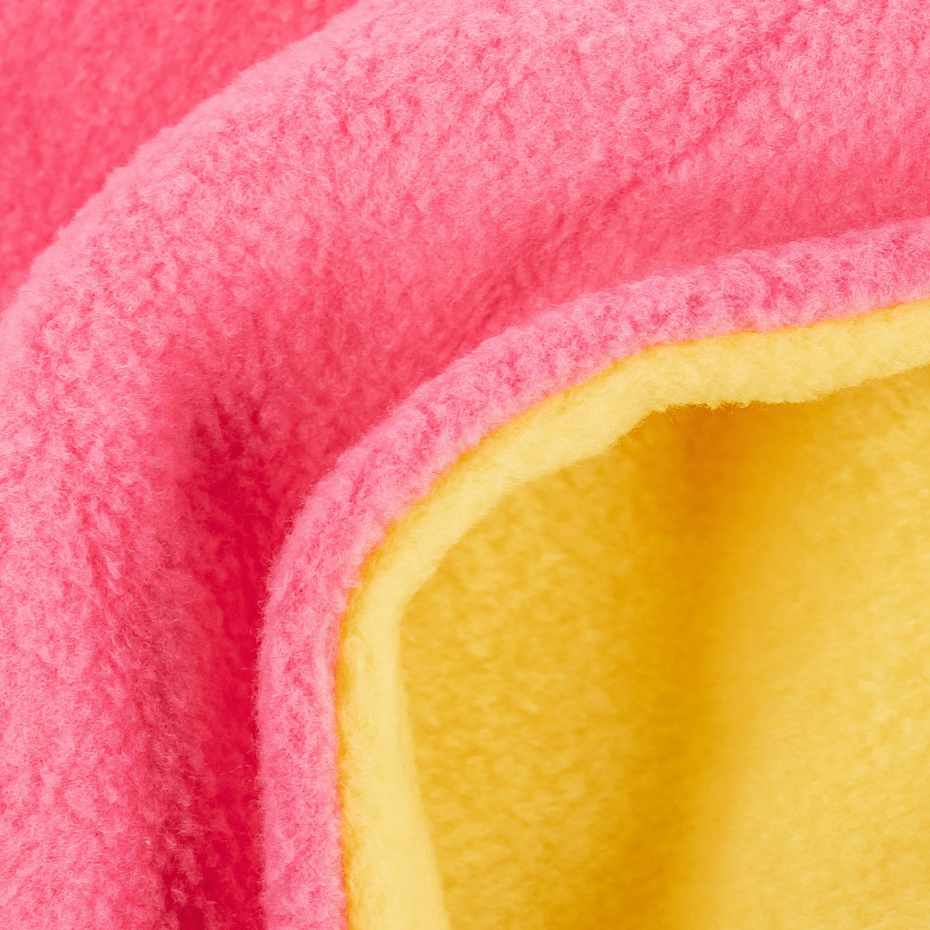 Fleece Neckwarmer - Skisister Edition 2 mit zweifarbigem Design, leuchtend pink und gelb, zeigt weiche, plüschige Textur.