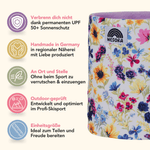 Printed Neckwarmer - Flower Garden mit floralem Muster, präsentiert neben Feature-Icons und deutscher Beschreibung, in einer Studioaufnahme von der Seite fotografiert.