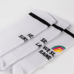Socken-Bundle mit gestreiften, gerippten Designs: SHE WAS A RAINBOW und teils verdecktem Motto, flach nebeneinander liegend, WESORA-Stil.